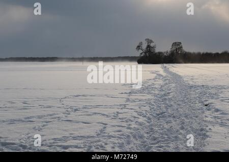 The Half - Timbered All Saints Church at Crowfield in Suffolk, England, under a layer of crisp white snow. Stock Photo