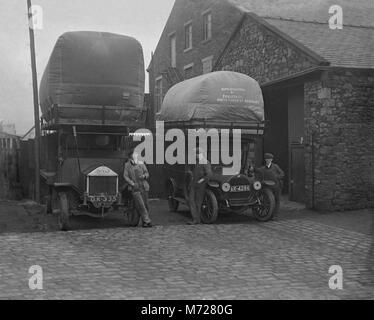 Two commercial vehicles and their drivers, West Yorkshire, England, UK c. 1917. They each have a massive bag containing coal gas on the roof. This gas was used to power the trucks. During World War I in the UK and Europe petrol (gasoline) supplies were almost non-existent in many areas. All available fuel was diverted to power military vehicles, boats and aircraft during the war efforts - so gas became an alternative fuel. Stock Photo