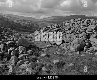 Pen y Gaer Iron Age hillfort, North Wales: view NW to Conwy valley & entrance (collapsed revetted passageway) through the western inner stone rampart. Stock Photo