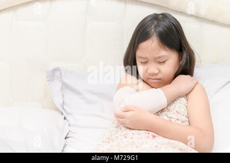 Little girl with her damaged right arm in gypsum cast and elastic bandage, Health concept Stock Photo