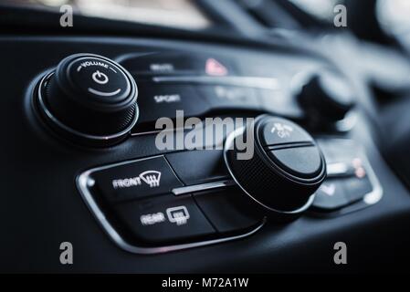 Car Dashboard Instruments Closeup Photo. Multimedia and Climate Control Buttons. Stock Photo
