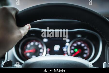 Hand on the Vehicle Steering Wheel. Car Road Trip Concept. Stock Photo