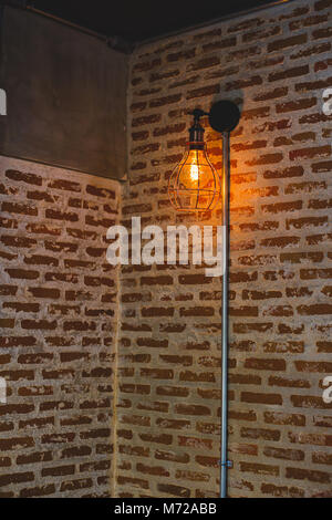 Decorative antique edison style light bulbs against brick wall background Stock Photo