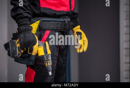Worker with Power Tool Preparing For Work. Closeup Photo. Construction Theme. Stock Photo