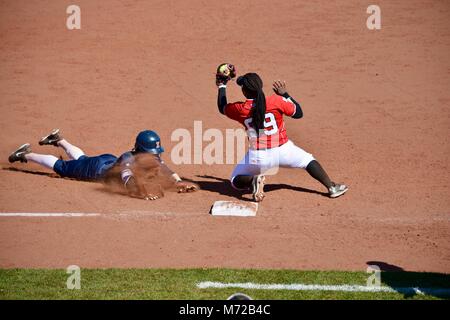 Sliding into third at a dastpitch softball game in Illinois Stock Photo