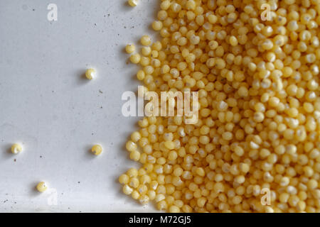 Yellow grain millet as texture or background The concept of proper nutrition and healthy lifestyle. Top view, close-up as background or texture Stock Photo