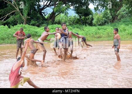 Fiji Islands, boys playing in a Taveuni river with homemade boat Stock ...