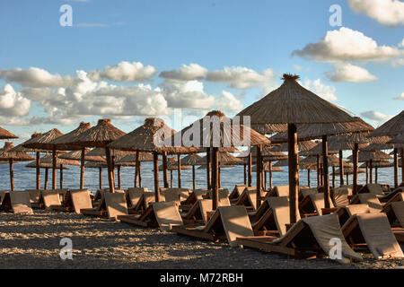 Sun loungers and umbrellas are on the beach in Budva, Montenegro. Stock Photo