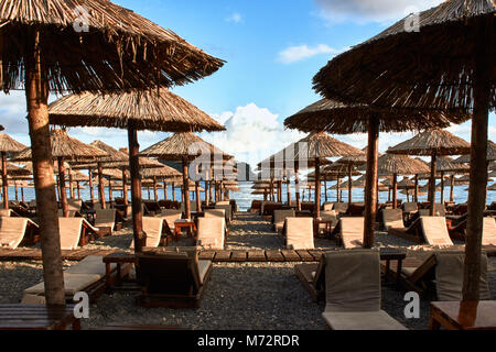 Sun loungers and umbrellas are on the beach in Budva, Montenegro. Stock Photo