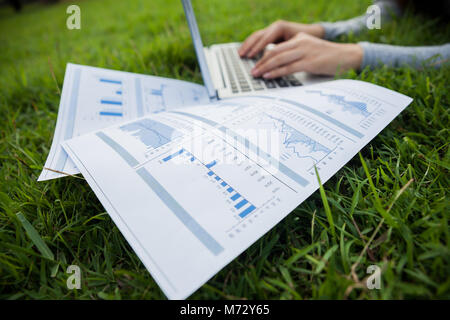 The woman checking reported profits in the garden. Stock Photo