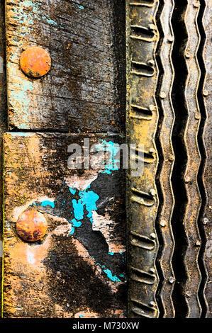 Close-up of an aging tire caked with dirt, rust and paint. Stock Photo