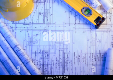 Workplace of architect. Rolls of blueprints, libela and helmet of constructor. Place for text. Stock Photo