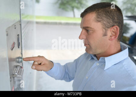 person using self service automatic car wash vacuum machine Stock Photo