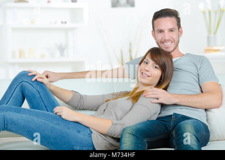 young couple relaxing on the sofa Stock Photo