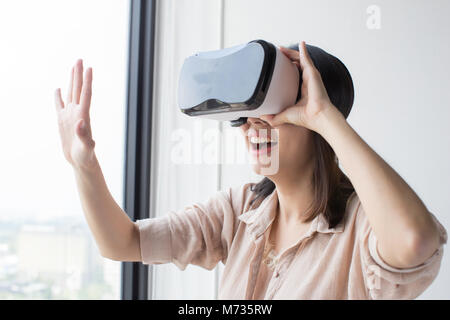 asian woman wear vr headset and enjoy experience Stock Photo