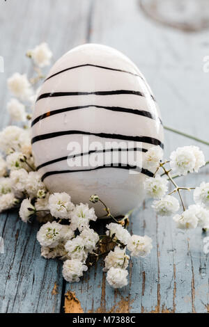 egg with black stripes and white flowers Stock Photo
