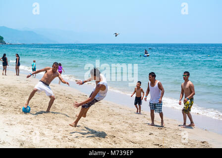 Puerto Vallarta, Jalisco, Mexico, Mexican men playing soccer on a beach, Editorial only. Stock Photo