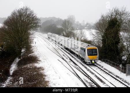 A Chiltern Railways train in snowy weather, Hatton Bank, Warwickshire, UK Stock Photo