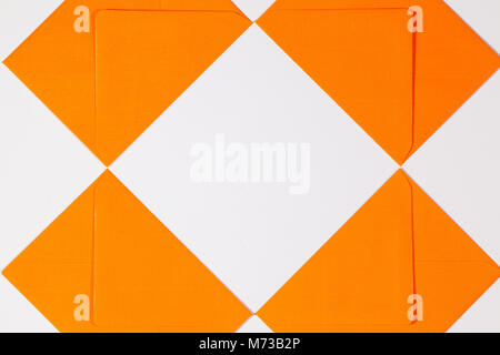 Pattern from orange envelopes on the white table Stock Photo