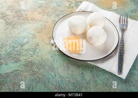 Cottage cheese balls with coconut and jam on white plate Stock Photo