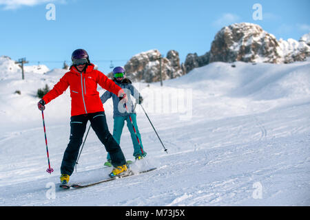 A female ski instructor teaches a woman in the French alpine resort of Courchevel. Stock Photo