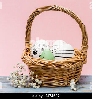 easter eggs in a basket with pink background Stock Photo
