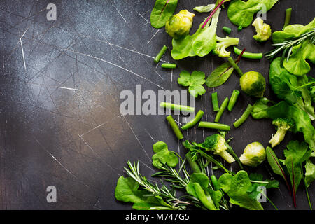 Food background. Various summer fresh herbs on a dark stone background. Diet, concept of vegetarian food. Copy space. Stock Photo