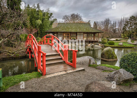 Red arch bridge in public Japanese garden in Toulouse, France Stock Photo