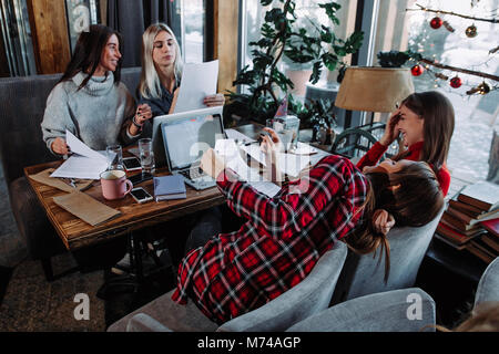 four colleagues having a conversation during the break. Stock Photo