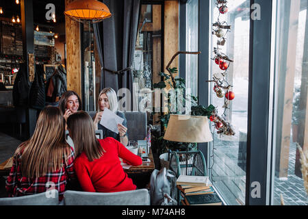 Group of happy business people analyzing business charts in a cafe. Stock Photo