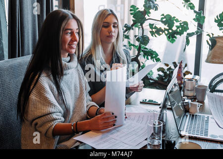 Two businesswoman working together about documents, partner discuss plan or idea and opinion meeting Stock Photo