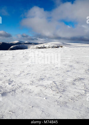 Looking over the top of Loch Brandy from the snow covered slops of Green Hill in Glen Clova, Angus. Stock Photo