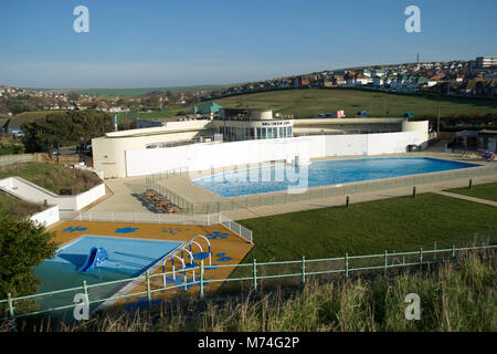 Saltdean Lido Art Deco refurbished outdoor kids swimming pool East Sussex South Downs green hills morning sunshine blue water Stock Photo