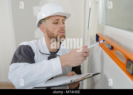 Contractor using spirit level Stock Photo
