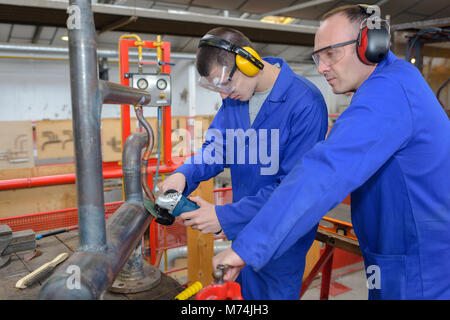 factory engineer operating hydraulic tube bender Stock Photo