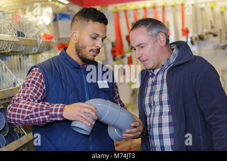 man selecting plumbing fittings from stores Stock Photo