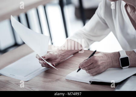 Close up of female hands that holding paper Stock Photo