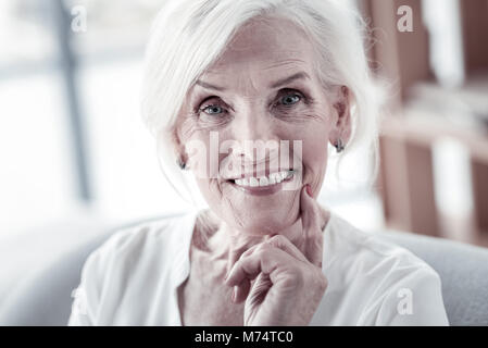 Delighted female person posing on camera Stock Photo