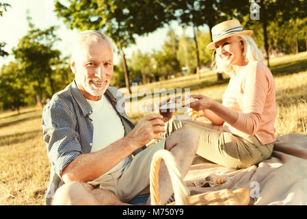 Happy elderly couple having a picnic Stock Photo