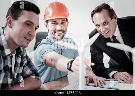 Delighted men studying new sources of energy Stock Photo