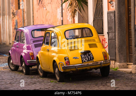 Two classic Fiat 500 cars parked on Trastevere backstreet, Rome, Lazio, Italy. Stock Photo