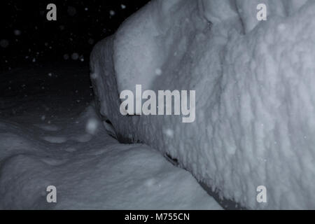 Snow buries a parked in 18 inches of snow.  Note mirror. Stock Photo