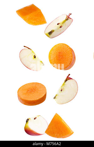 Isolated falling fruits. Falling apple and carrot isolated on white background with clipping path as package design element. Stock Photo