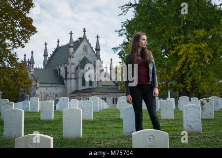 Memorial Day. A Young Girl Pays Respect for those that have Fought and Died for her Freedom, Tombstones at Crown Hill Cemetery, Indianapolis, Indiana Stock Photo