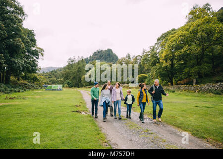 Three generation family are leaving the campsite they are staying in to go for a hike. Stock Photo