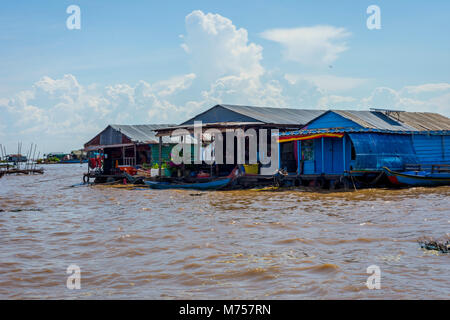 TONLE SAP, CAMBODIA - APRIL 8: People sitting in front of the boat house in Tonle Sap floating village. April 2017 Stock Photo