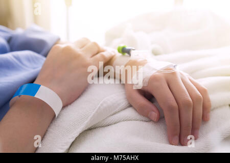 female patient sleeping on the patient bed in the room after surgery at the hospital with sunbeem. Stock Photo