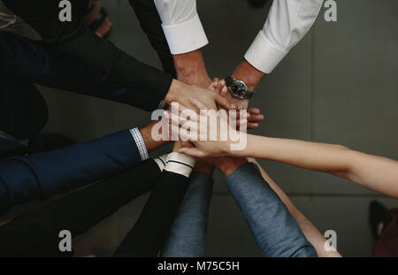 Team work and cooperation concept. Business people joining hands showing unity. Stock Photo
