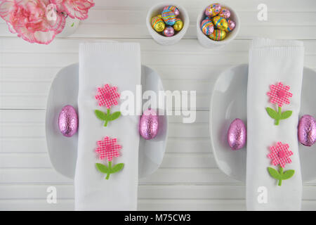 colorful Easter table place setting on white Stock Photo