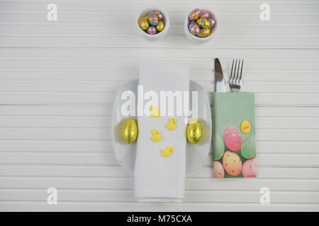 colorful Easter table place setting on white Stock Photo